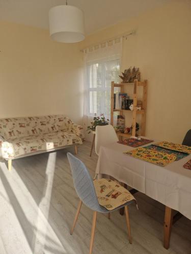 a living room with a couch and a table and chairs at Lovely Home by the Beach in Kruče