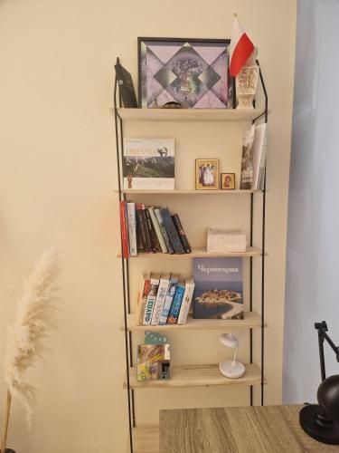 a book shelf filled with books in a room at Lovely Home by the Beach in Kruče