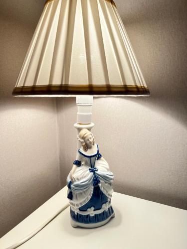a blue and white lamp sitting on top of a table at Cozy room surrounded by nature in Falun