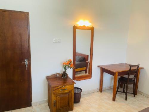 a room with a table and a mirror and a chair at Yala Hotel Grand View in Tissamaharama