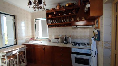 a small kitchen with a stove and a sink at Casa de Penela in Penela