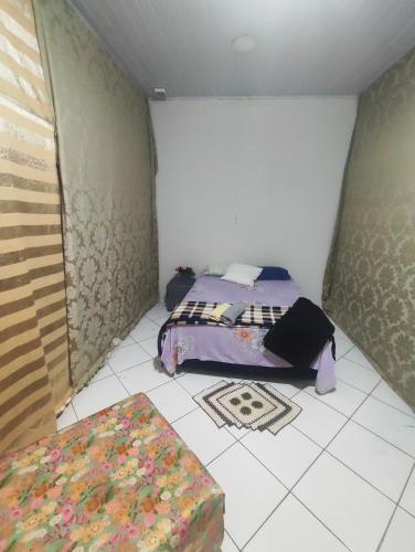 Una cama o camas en una habitación de Pousada Nova Jerusalém