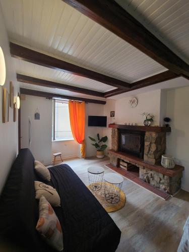 a living room with a couch and a fireplace at Maison auvergnate entièrement rénovée in Brioude