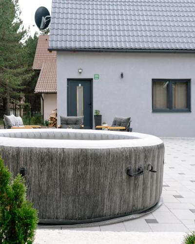 a circular pool in front of a house at Vikendica Marija Blidinje in Blidinje