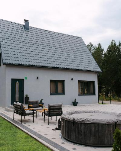 a large white building with a hot tub in front of it at Vikendica Marija Blidinje in Blidinje