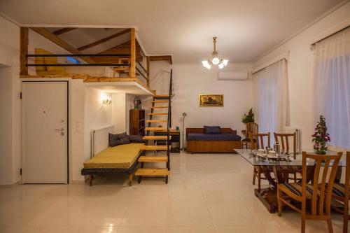 a living room with a loft bed and a table at Argo Luxury House in Volos