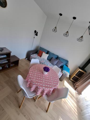 a living room with a table and chairs and a bed at Kotedžas poilsiui in Palanga
