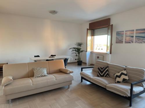 a living room with two couches and a table at Torrione view apartment in Spilamberto