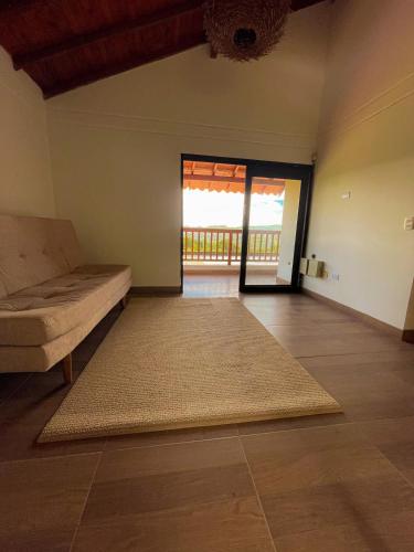 a living room with a couch and a large rug at Casa campestre guarne in Guarne