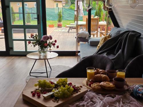 a table with a tray of grapes and bread and juice at Api Aframe in Avrig