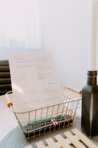 a shopping basket with a piece of paper and a bottle at Kupferdachl in Sankt Lambrecht