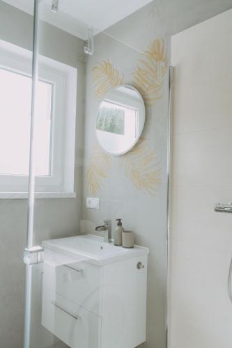 a bathroom with a sink and a mirror on the wall at Kupferdachl in Sankt Lambrecht