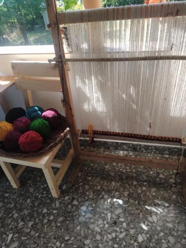 a basket of yarn sitting on a shelf next to a window at Vardzia Old Village in Vardzia
