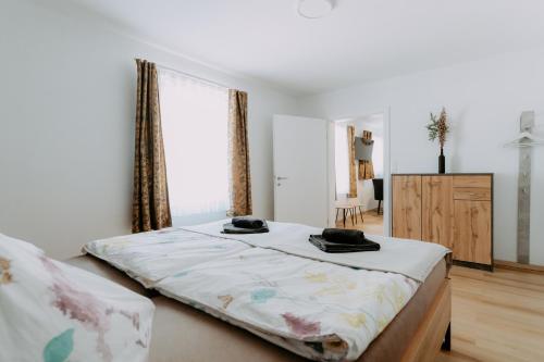 a bedroom with a bed and a dresser and a window at Kupferdachl in Sankt Lambrecht