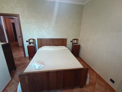a bedroom with a large bed with a wooden frame at La Fonte B&B in Baranello