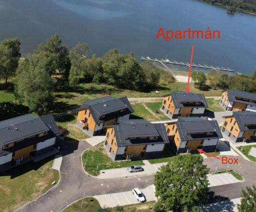 an aerial view of a apartment complex with a body of water at Rodinný apartmán s balkónem a dvěma koupelnami in Černá v Pošumaví