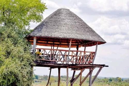 a hut with a person sitting in it at Mawila Big Five Lodge in Liwonde