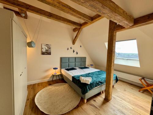 a bedroom with a bed and a large window at EngelHaus Fürth in Fürth