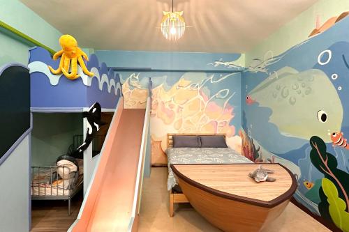 a childs room with a bunk bed and a slide at Wawa Ocean Family B&B in Taitung City