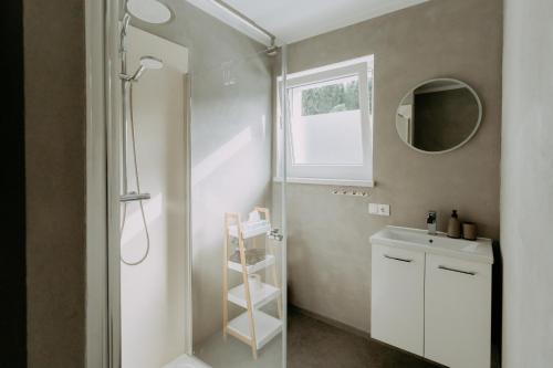 a bathroom with a shower and a sink and a mirror at Kupferdachl in Sankt Lambrecht