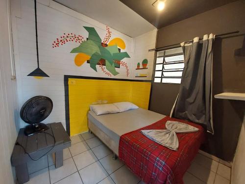 a small bedroom with a bed and a chair at Hostel Pantanal Em Florianópolis in Florianópolis