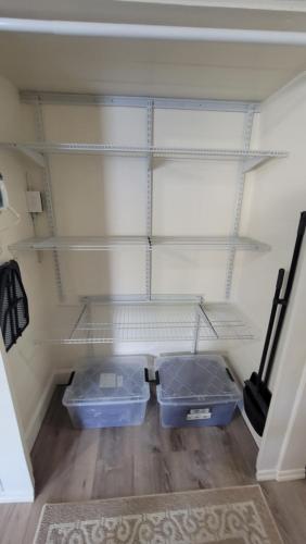 two plastic bins are sitting in a closet at Downtown Juneau Gold Street Apartments in Juneau