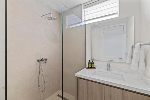 a bathroom with a sink and a shower at The Park in Grace Bay in The Bight Settlements