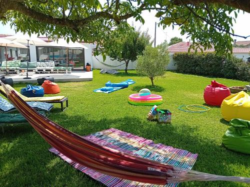 a hammock in the grass under a tree at Casa dos Avós Veras in Aveiro