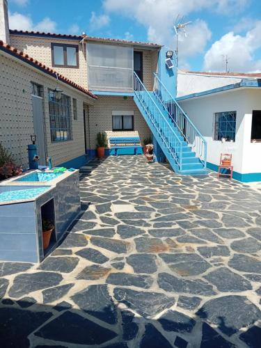 a patio with a staircase leading to a house at Casa dos Avós Veras in Aveiro