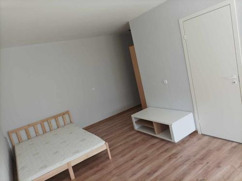 a small room with a bed and a table at Single Room Apartment in Jonava in Jonava