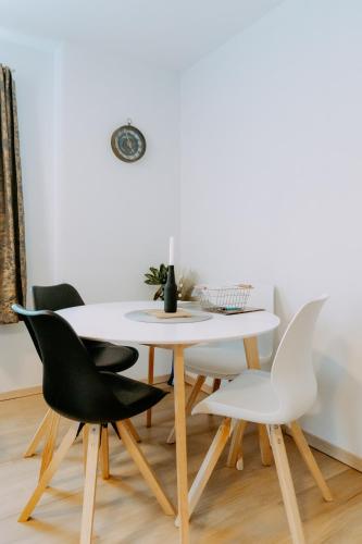 a dining room with a white table and chairs at Kupferdachl in Sankt Lambrecht