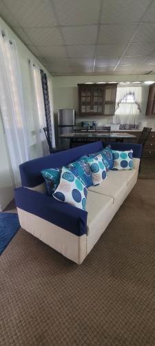 a bed with pillows on it in a room at Casa verde in Tunapuna