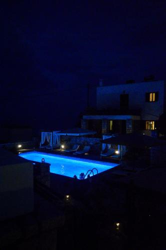 a swimming pool lit up at night at Malvazios Villas #3 in Gythio