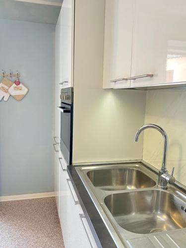 a kitchen with a stainless steel sink and a stove at Dolce Settembre in Châtillon