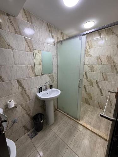a bathroom with a sink and a shower at Middle East pyramids veiw &jacuzzi in Cairo