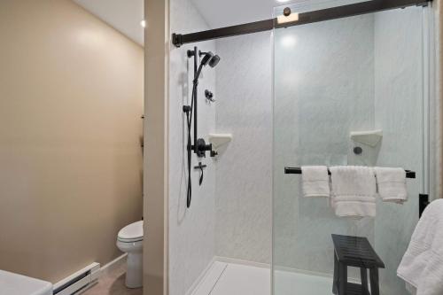 a bathroom with a shower with a glass door at 3 Bedroom Townhouse Across from HoliMont in Ellicottville
