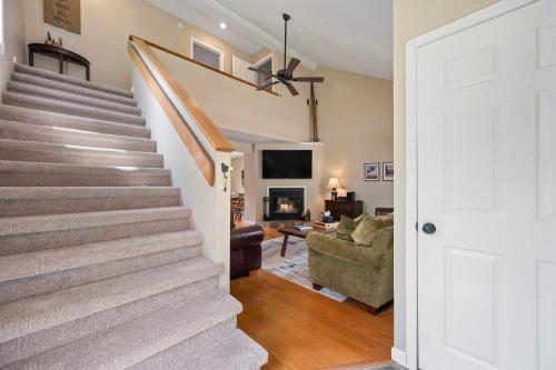 a staircase in a home with a living room at 3 Bedroom Townhouse Across from HoliMont in Ellicottville