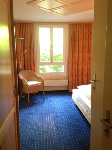 a hotel room with a bed and a window at Hotel Bellevue - Traditional Swiss Hideaway in Wengen