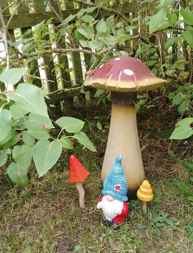a group of stuffed mushrooms sitting next to a mushroom at Jules Heim mit Herz in Hanshagen