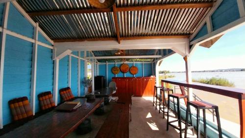 a dining room with a table and some chairs at Don Som Riverside Guesthouse in Don Som