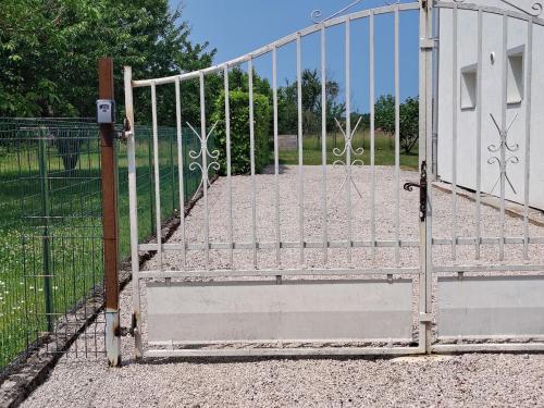 an open gate to a driveway with at Appartement calme avec jardin in Saint-Ambreuil