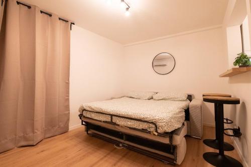 a small bedroom with a bed and a table at Studio Place Masséna in Nice