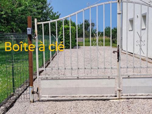 an open gate of a gate with at Appartement calme avec jardin in Saint-Ambreuil