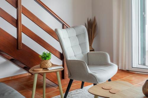 a living room with a chair and a table at Casas do Porto in Mosteiros