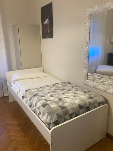 a bed in a room with a mirror at Home in Arezzo