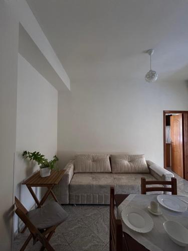 a living room with a couch and a table at Graci Apartments in Sarandë