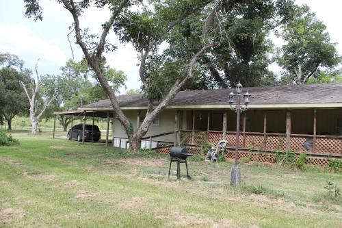 a house with a grill in front of it at Countryside Bliss - Entire Home on 2 Acres in Rosharon