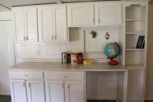 a kitchen with white cabinets and a counter top at Countryside Bliss - Entire Home on 2 Acres in Rosharon