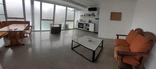 a living room with a couch and a table at Aptos FRERS 3 in Martínez