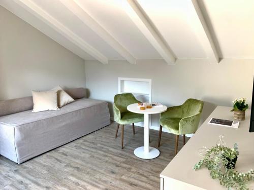 a living room with a couch and a table at Alchimia WellResort in Comano Terme